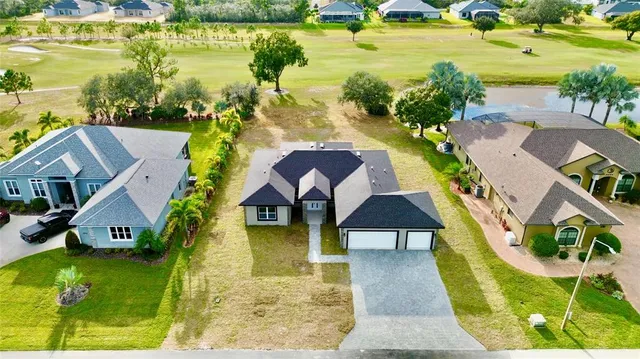 an aerial view of residential houses with outdoor space and swimming pool