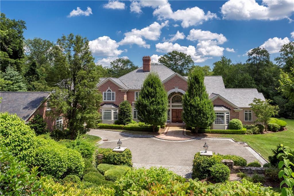 93 Clapboard Ridge Road Greenwich, CT 06830 - Photo 1 of 1 a front view of a house with garden