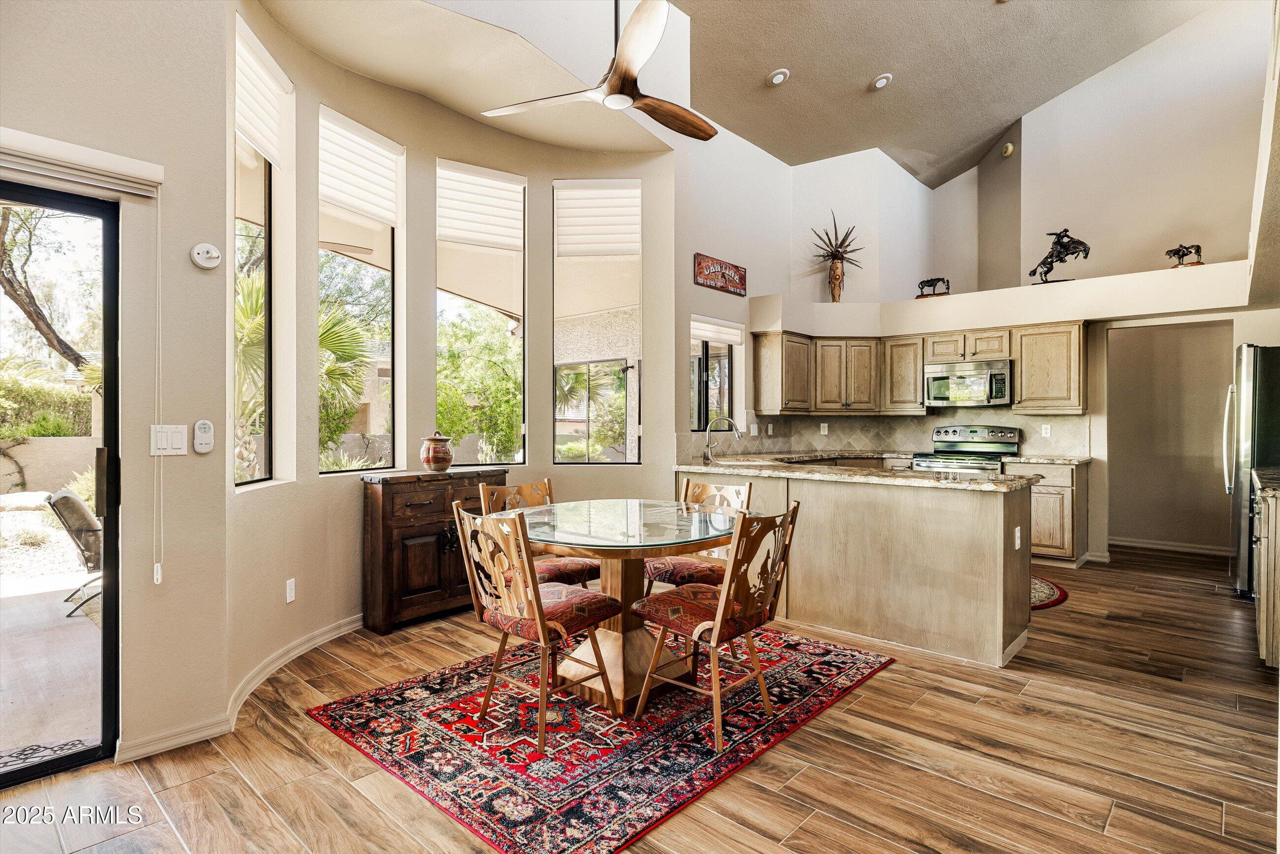 25821 North Bolero Bend Rio Verde, AZ 85263 - Photo 14 of 42 a view of a dining room with furniture window and wooden floor