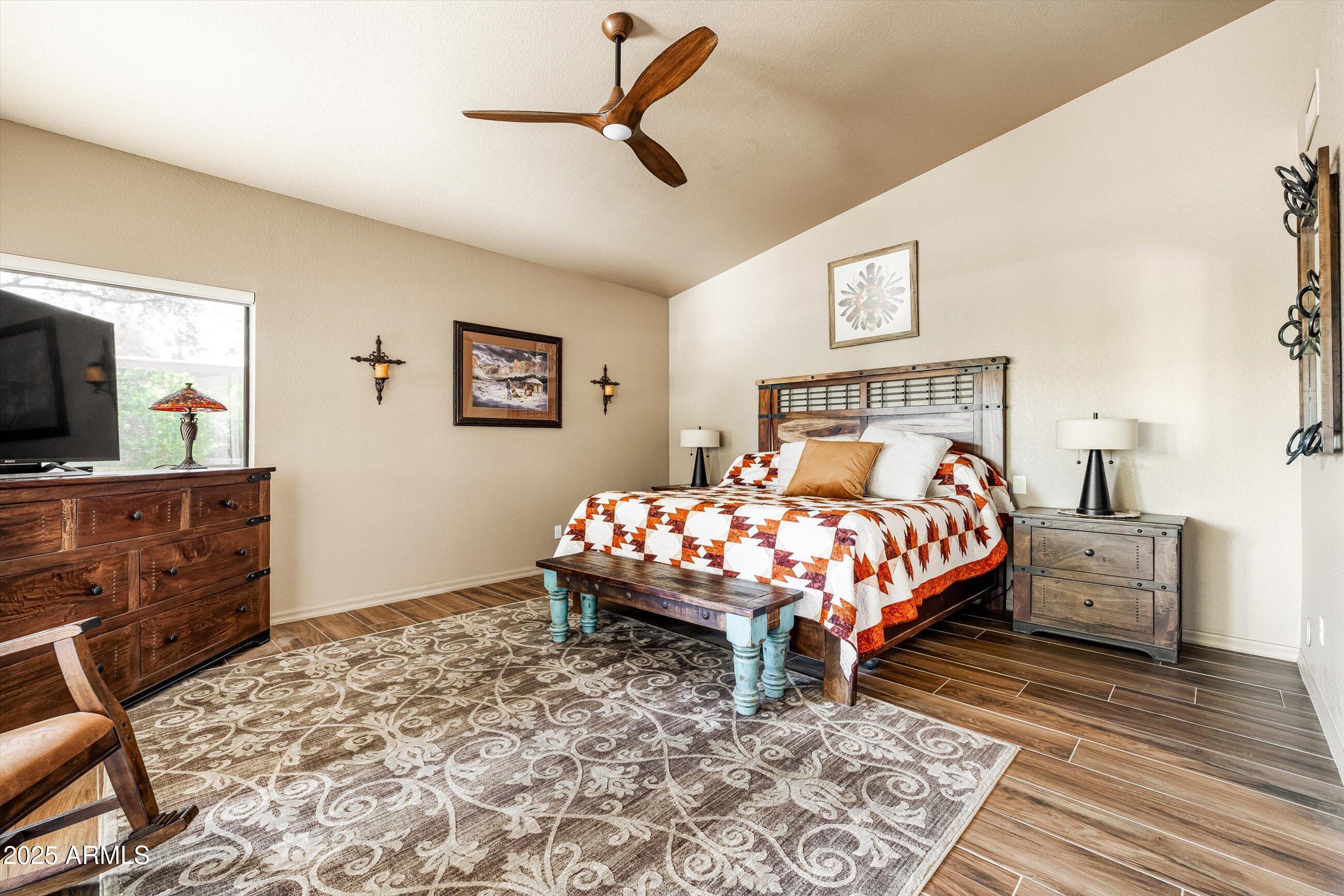 25821 North Bolero Bend Rio Verde, AZ 85263 - Photo 17 of 42 a bed sitting in a bedroom and chandelier