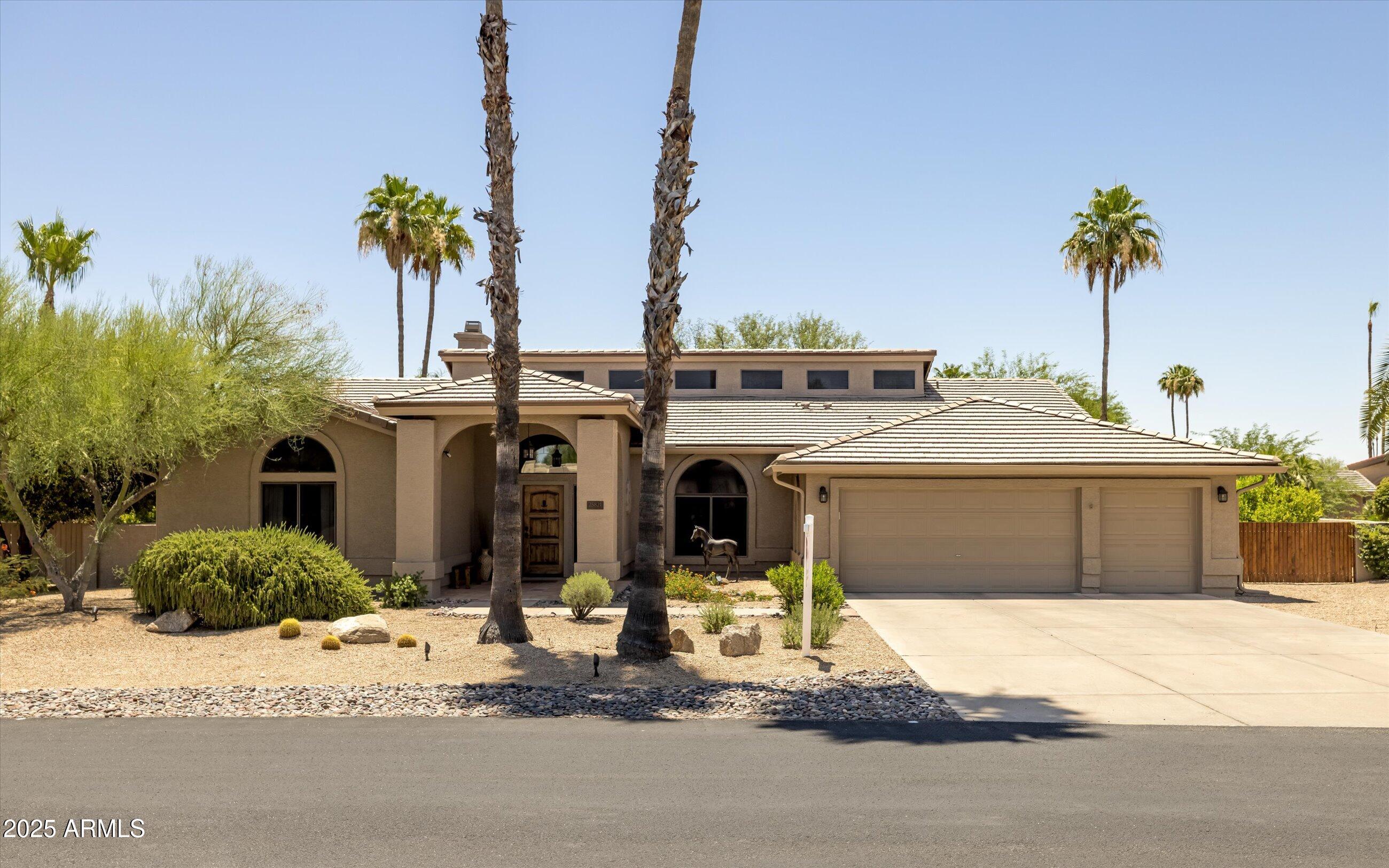 25821 North Bolero Bend Rio Verde, AZ 85263 - Photo 4 of 42 a front view of a house with a yard and a garage