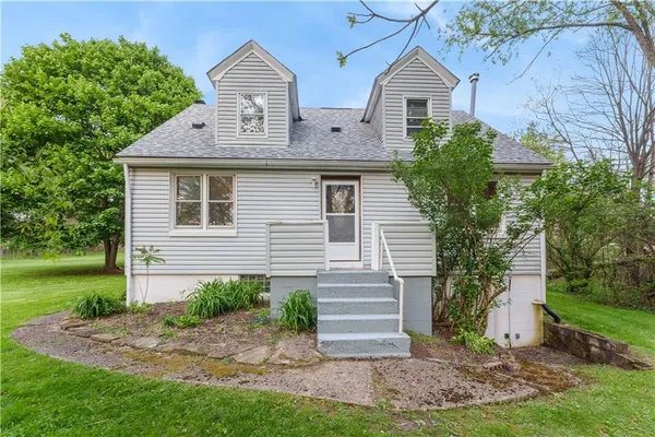a front view of a house with a yard and an outdoor seating
