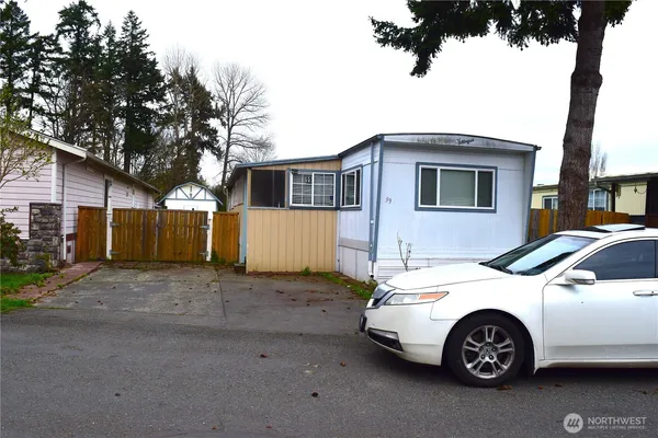 a front view of a house with parking space