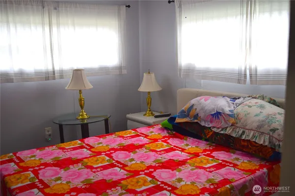 a bedroom with a bed and a lamp