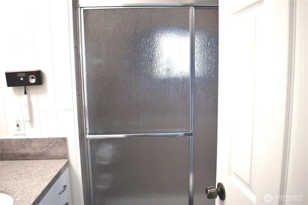 a bathroom with a shower and a sink