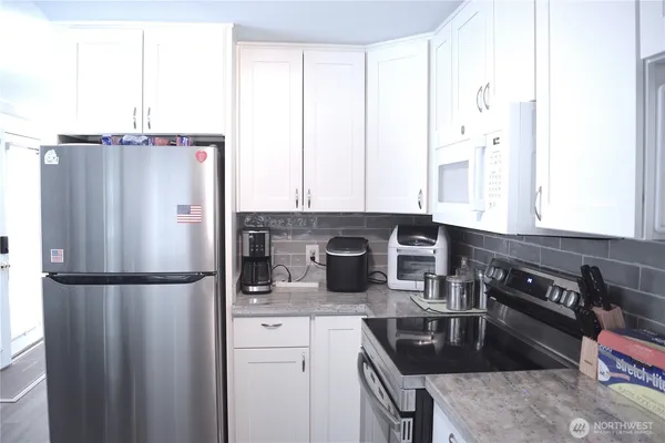 a kitchen with a refrigerator and a sink