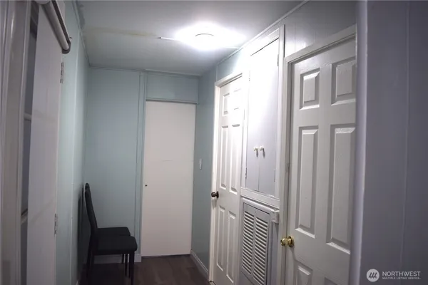 a view of a hallway with wooden floor