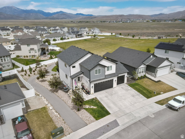 7889 Bristlecone Road Eagle Mountain, UT 84005 - Photo 4 of 42 Modern two-story residence featuring a gray and white exterior with dark roof shingles