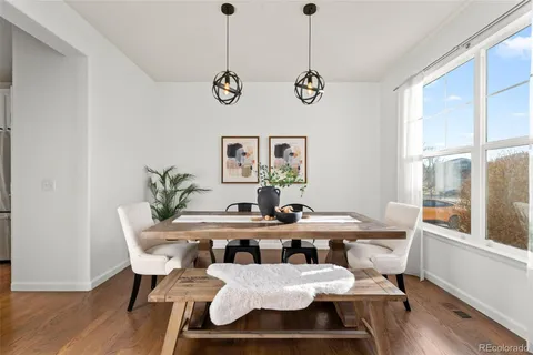 a view of a dining room with furniture window and wooden floor