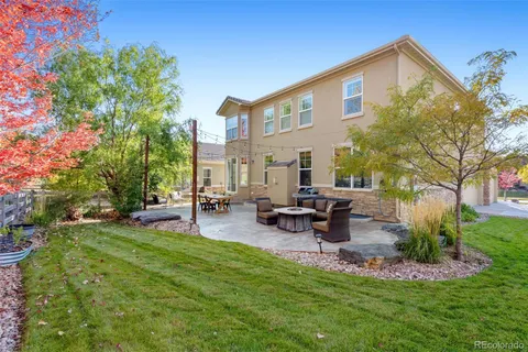 a view of a house with backyard and sitting area