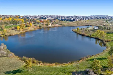 a view of a lake with boats and trees in the background