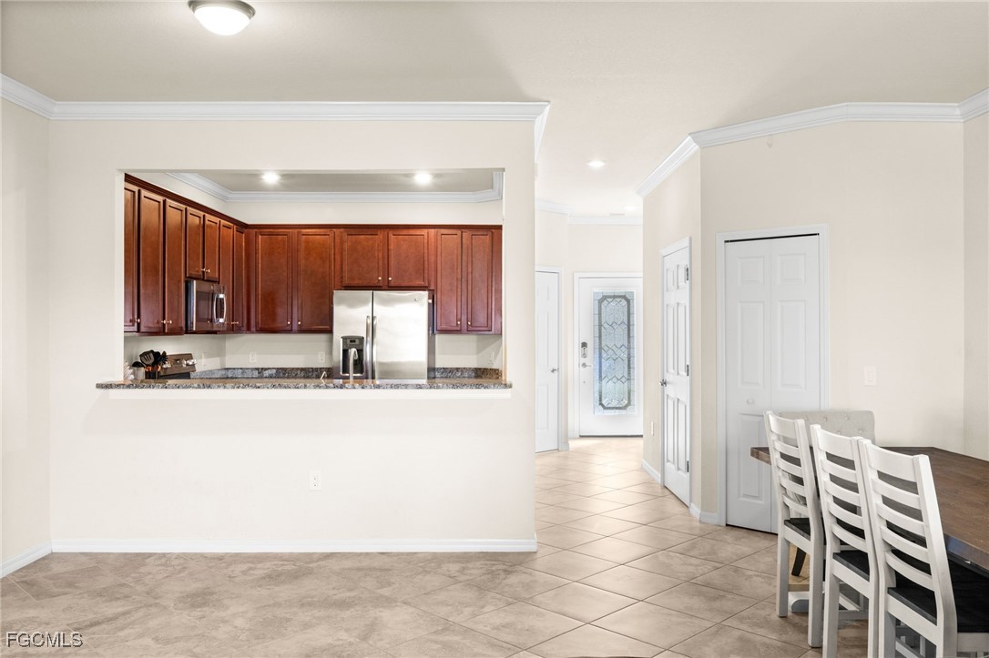 10173 Via Colomba Circle Fort Myers, FL 33966 - Photo 14 of 50 a large kitchen with a table and chairs in it