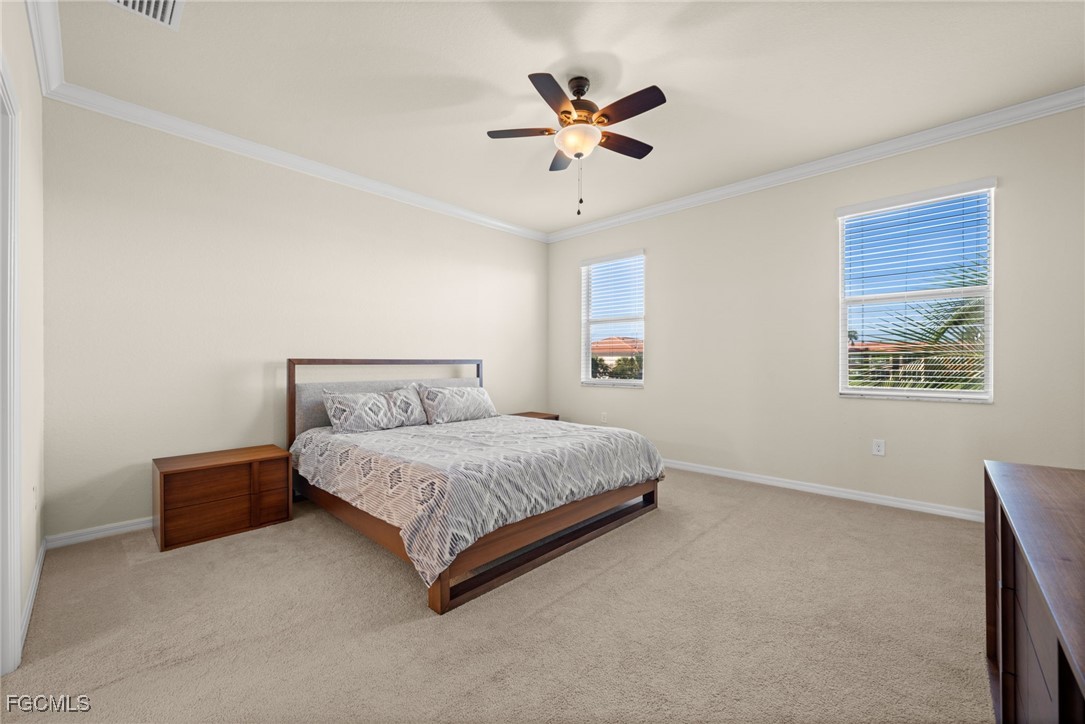 10173 Via Colomba Circle Fort Myers, FL 33966 - Photo 23 of 50 a bed room with a bed and a ceiling fan