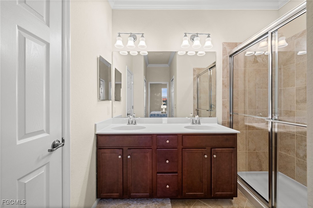 10173 Via Colomba Circle Fort Myers, FL 33966 - Photo 26 of 50 a bathroom with a double vanity sink and a mirror