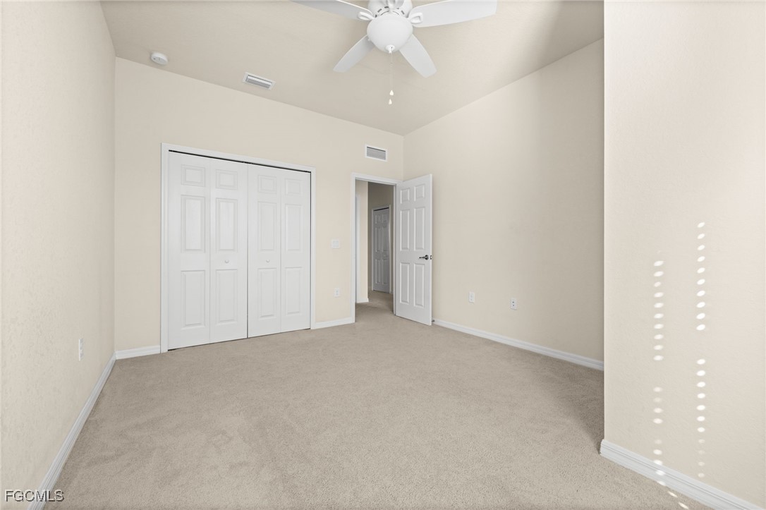10173 Via Colomba Circle Fort Myers, FL 33966 - Photo 29 of 50 an empty room with a ceiling fan and a window