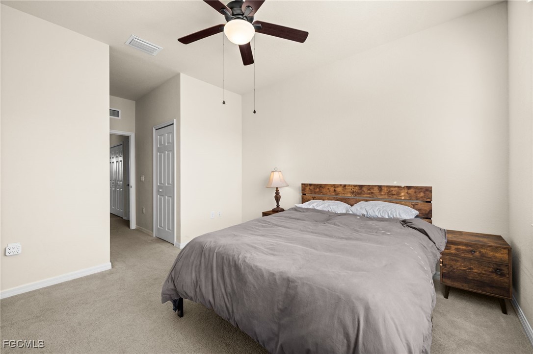 10173 Via Colomba Circle Fort Myers, FL 33966 - Photo 32 of 50 a bedroom with a bed and a ceiling fan