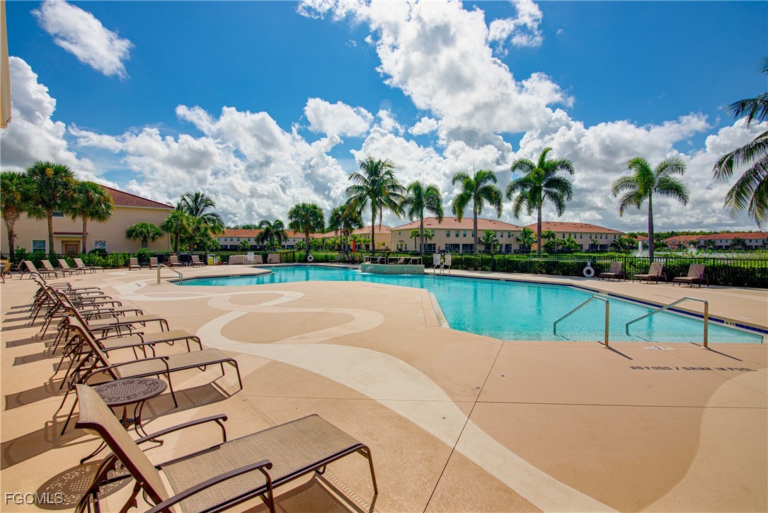 10173 Via Colomba Circle Fort Myers, FL 33966 - Photo 44 of 50 a view of swimming pool with seating area and trees in the background