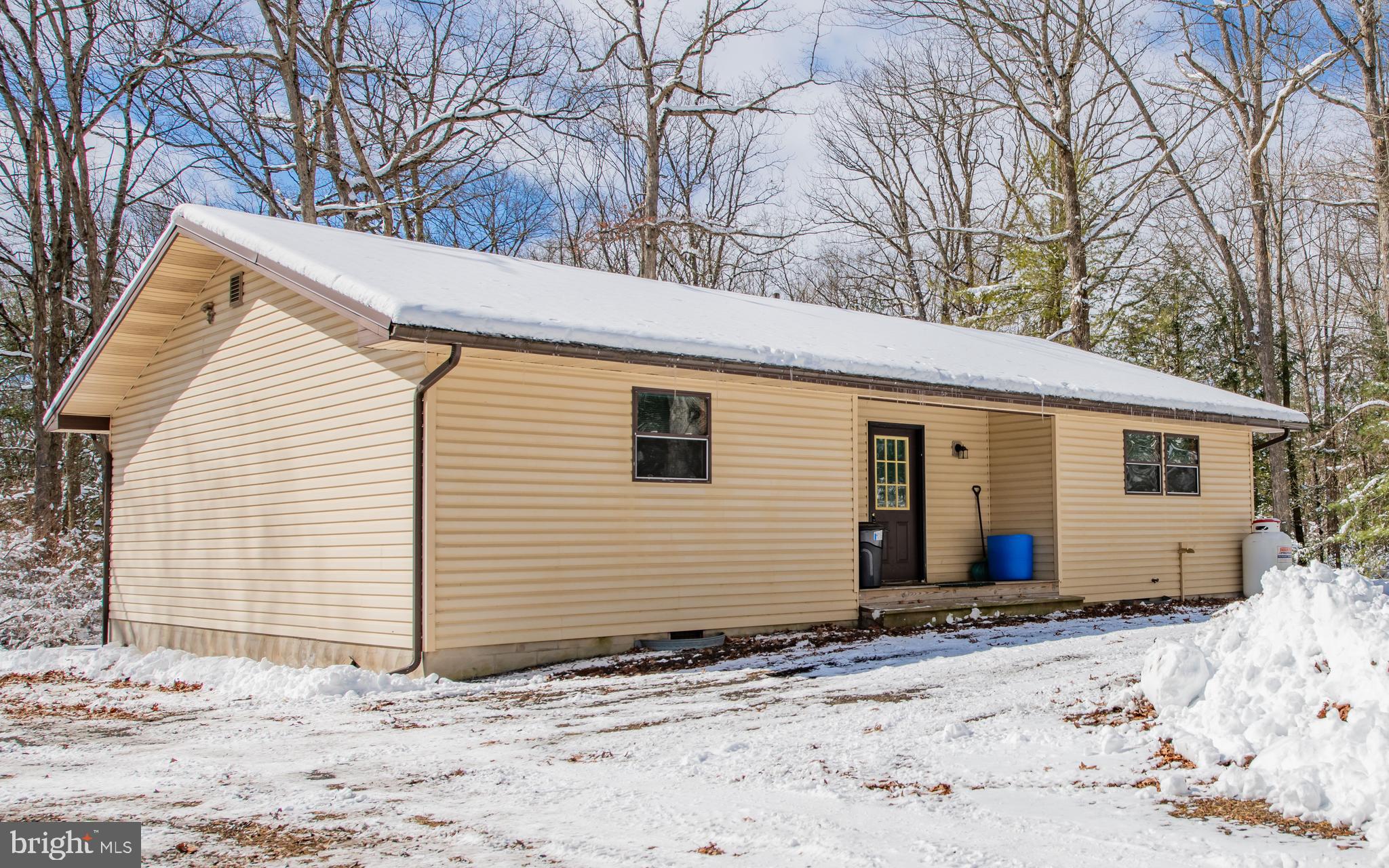 a view of a house with a yard covered in snow