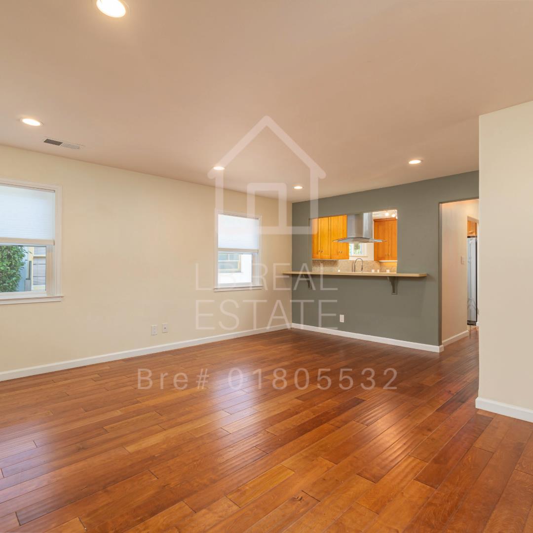 1382 Sir Francis Drake Boulevard San Anselmo, CA 94960 - Photo 2 of 16 a view of an empty room with wooden floor and a window
