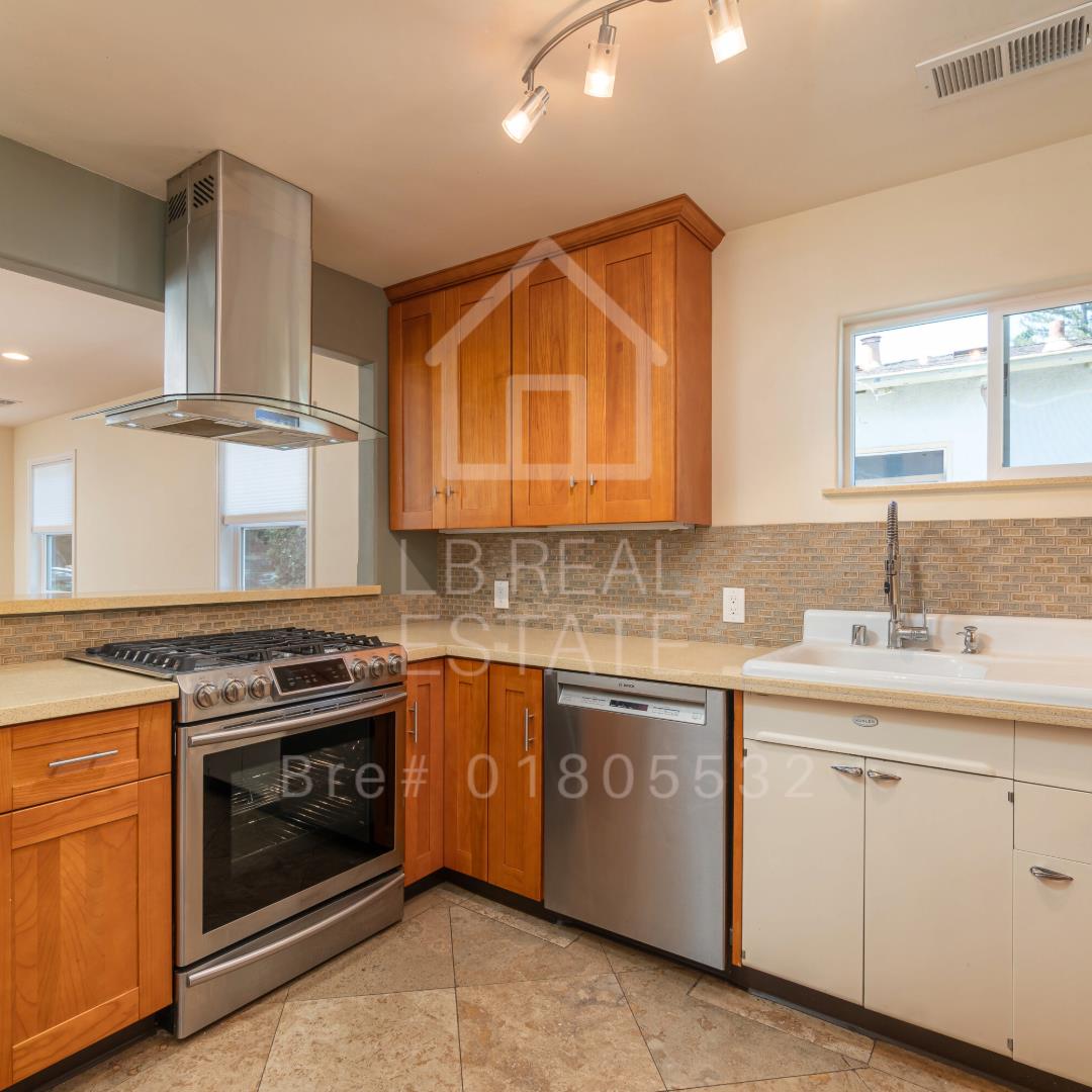 1382 Sir Francis Drake Boulevard San Anselmo, CA 94960 - Photo 5 of 16 a kitchen with a sink stove and cabinets