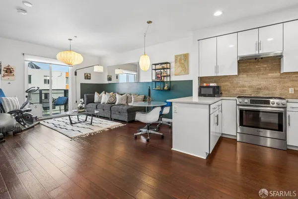 a living room with furniture a dining table and kitchen view