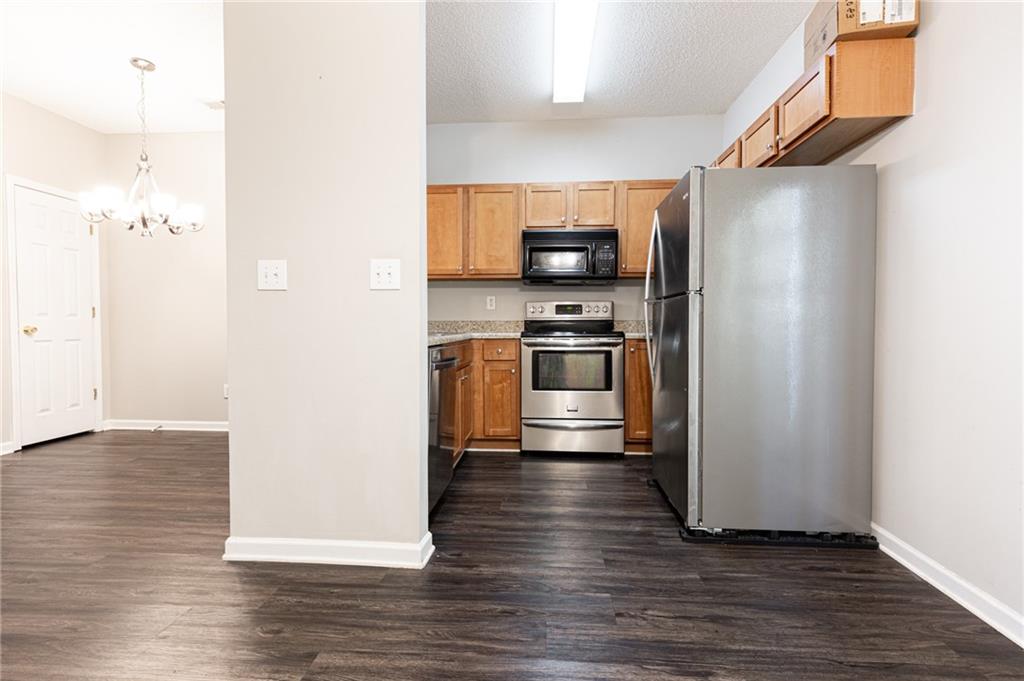3622 Ginnis Road, Unit 5 Atlanta, GA 30331 - Photo 13 of 29 a kitchen with stainless steel appliances a refrigerator and a stove top oven