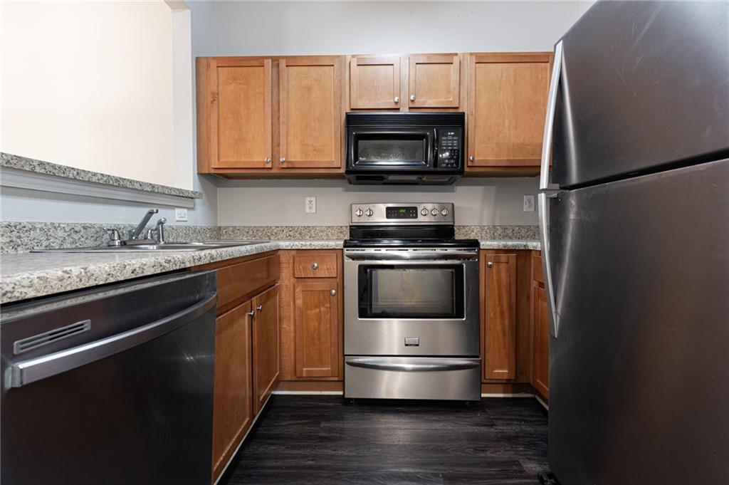 3622 Ginnis Road, Unit 5 Atlanta, GA 30331 - Photo 14 of 29 a kitchen with kitchen island a sink stainless steel appliances and cabinets