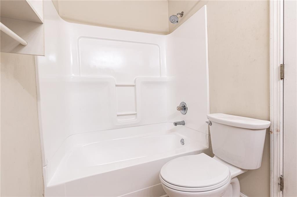 3622 Ginnis Road, Unit 5 Atlanta, GA 30331 - Photo 19 of 29 a white toilet sitting next to a bath tub