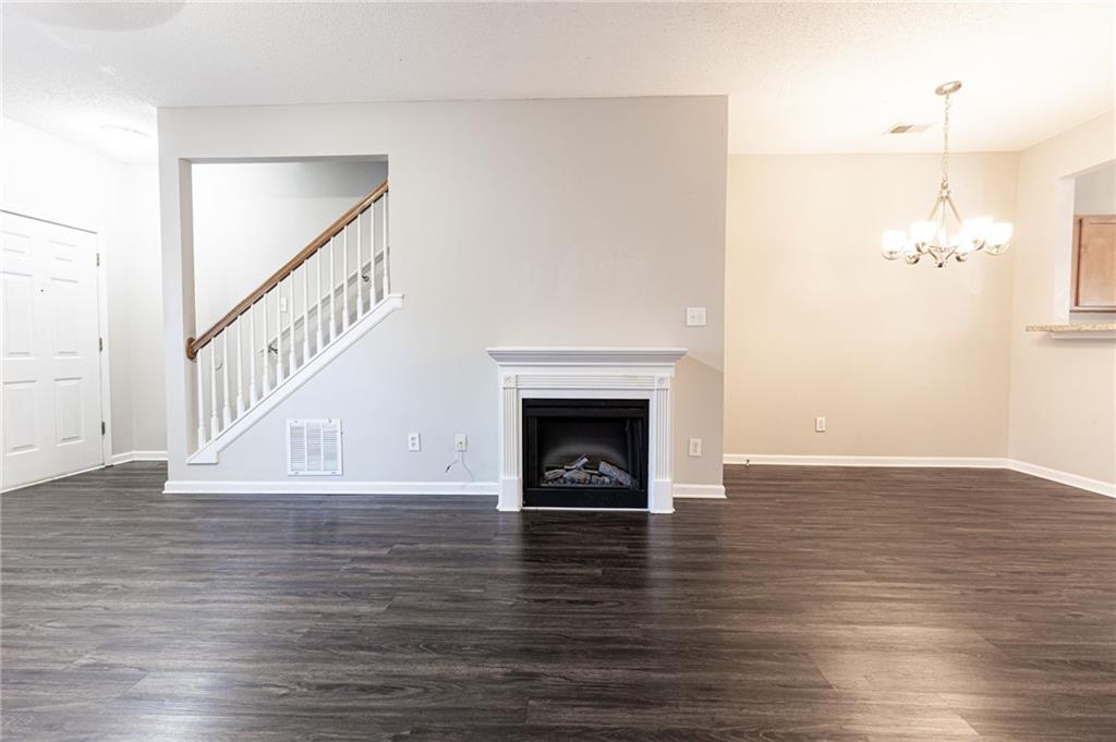 3622 Ginnis Road, Unit 5 Atlanta, GA 30331 - Photo 6 of 29 a view of an empty room with wooden floor fireplace and a window