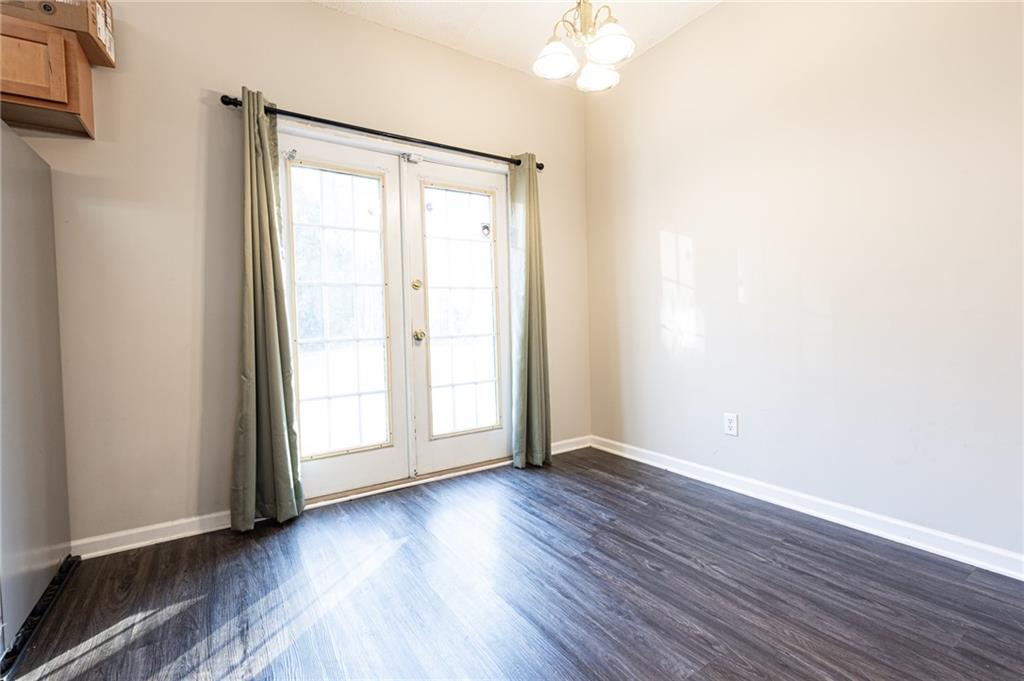 3622 Ginnis Road, Unit 5 Atlanta, GA 30331 - Photo 10 of 29 an empty room with wooden floor and windows