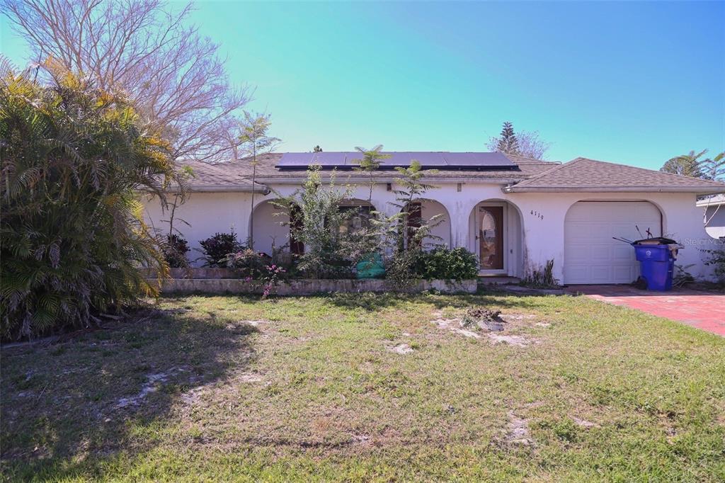 4119 Tangier Street Sebring, FL 33872 - Photo 1 of 1 a front view of a house with a yard and garage