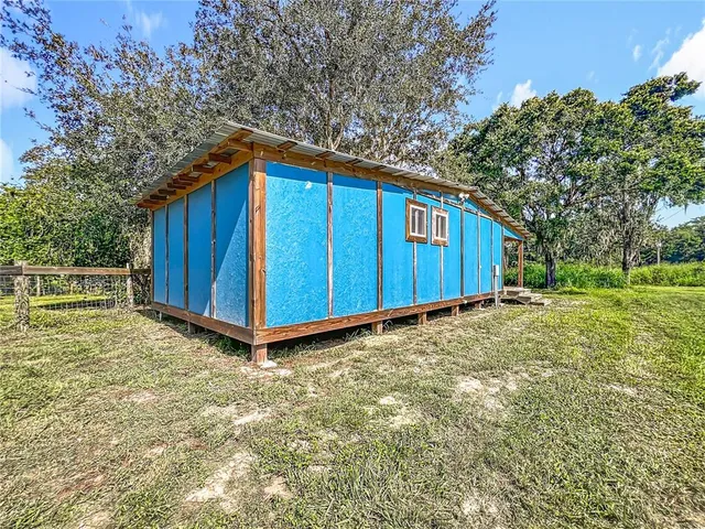 a view of backyard with wooden fence