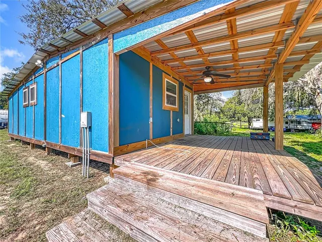 a view of backyard with a wooden deck