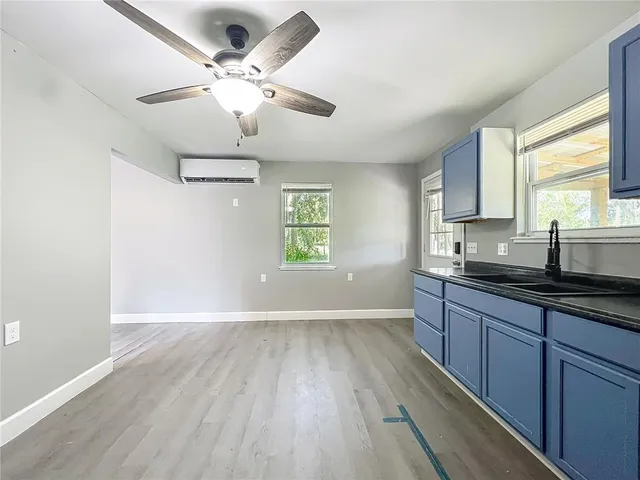 a view of kitchen with sink and wooden floor