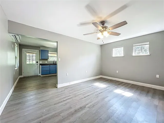 wooden floor in an empty room with a window