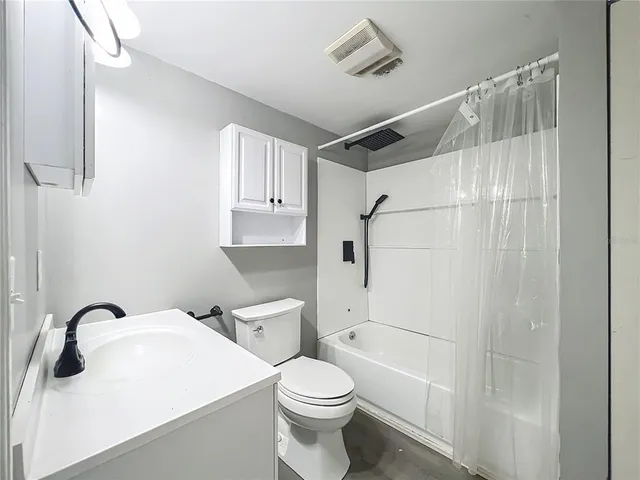 a white toilet sitting next to a bathroom sink