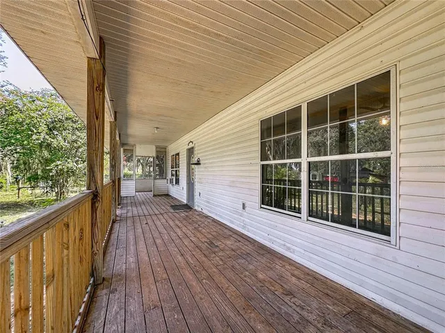 a view of a balcony with wooden floor