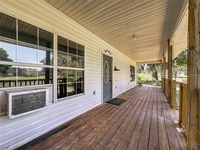 a view of a balcony with wooden floor