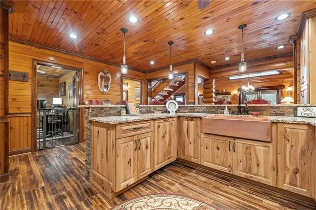 a bathroom with a granite countertop sink a toilet and shower