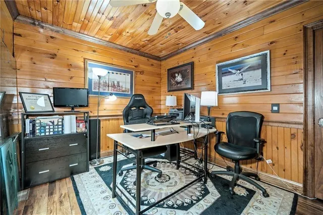 a dining room with furniture a rug and wooden floor