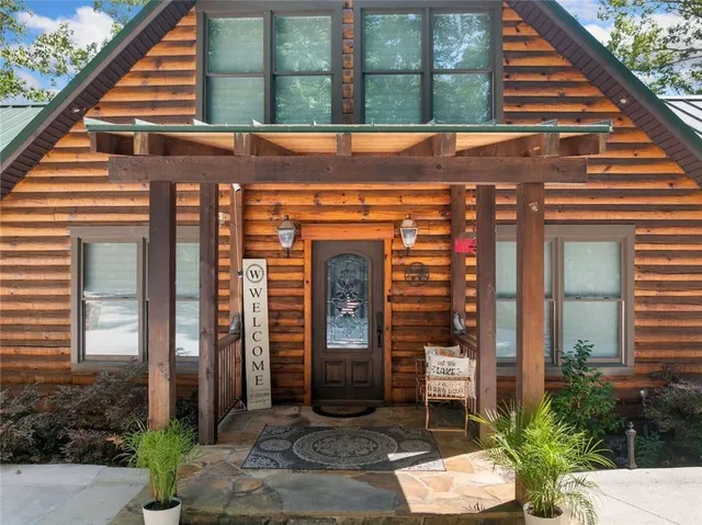 a view of a patio with table and chairs and potted plants
