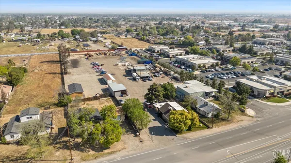 an aerial view of residential houses with city view