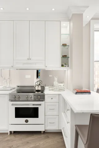 a kitchen with cabinets appliances a sink and a stove