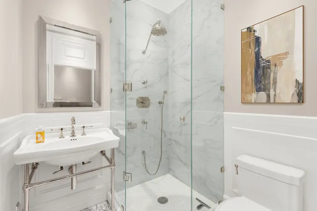 a bedroom with a bed and glass windows