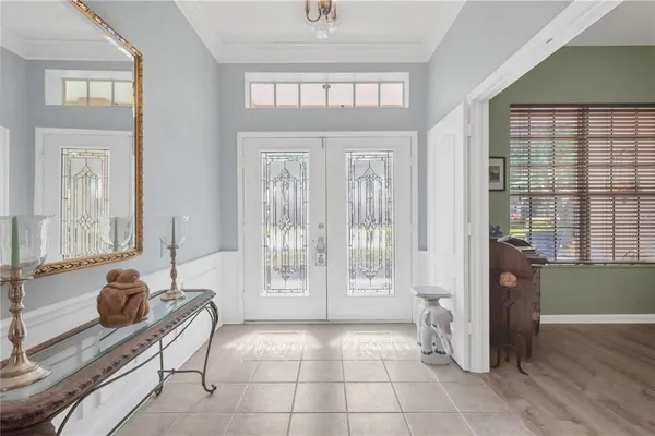 a living room with furniture and a floor to ceiling window