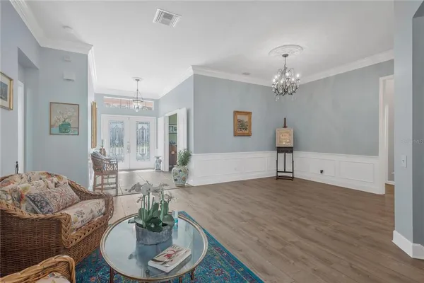 a living room with furniture and a dining table