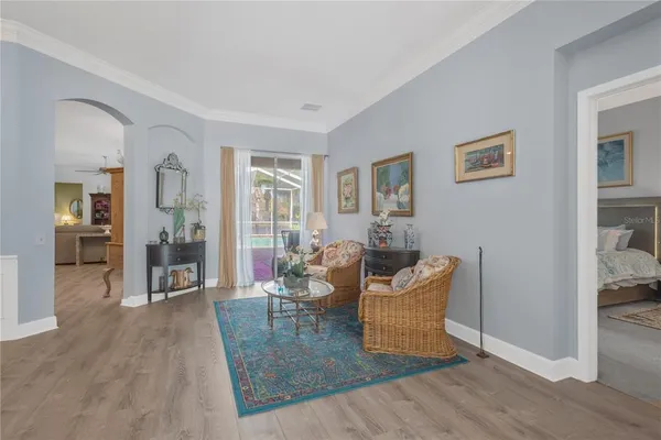 a living room with furniture and wooden floor