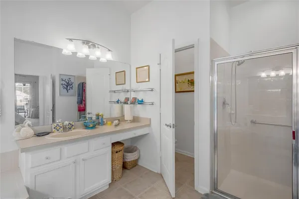 a bathroom with a double vanity sink mirror and shower