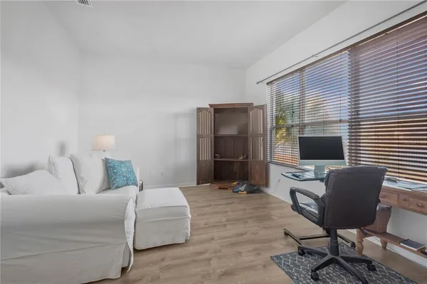 a living room with furniture a flat screen tv and a large window