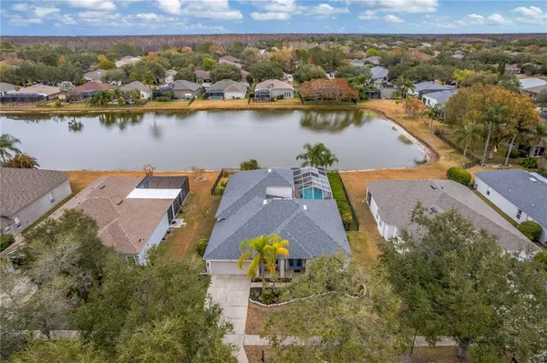 an aerial view of house with yard lake and ocean view
